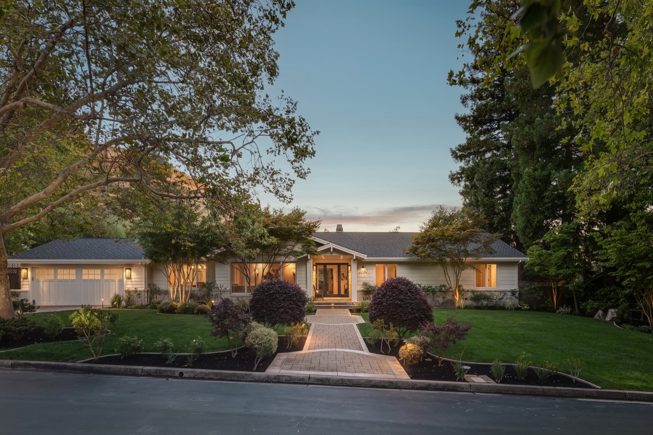 The single-level residence at twilight.